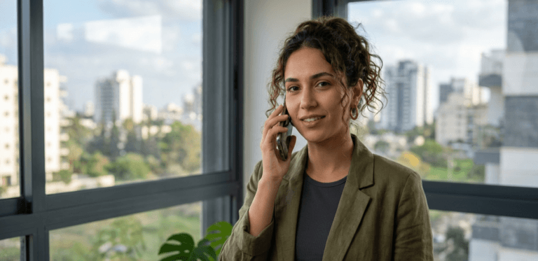 Confident person speaking in English on their phone near a bright window as part of a daily habit